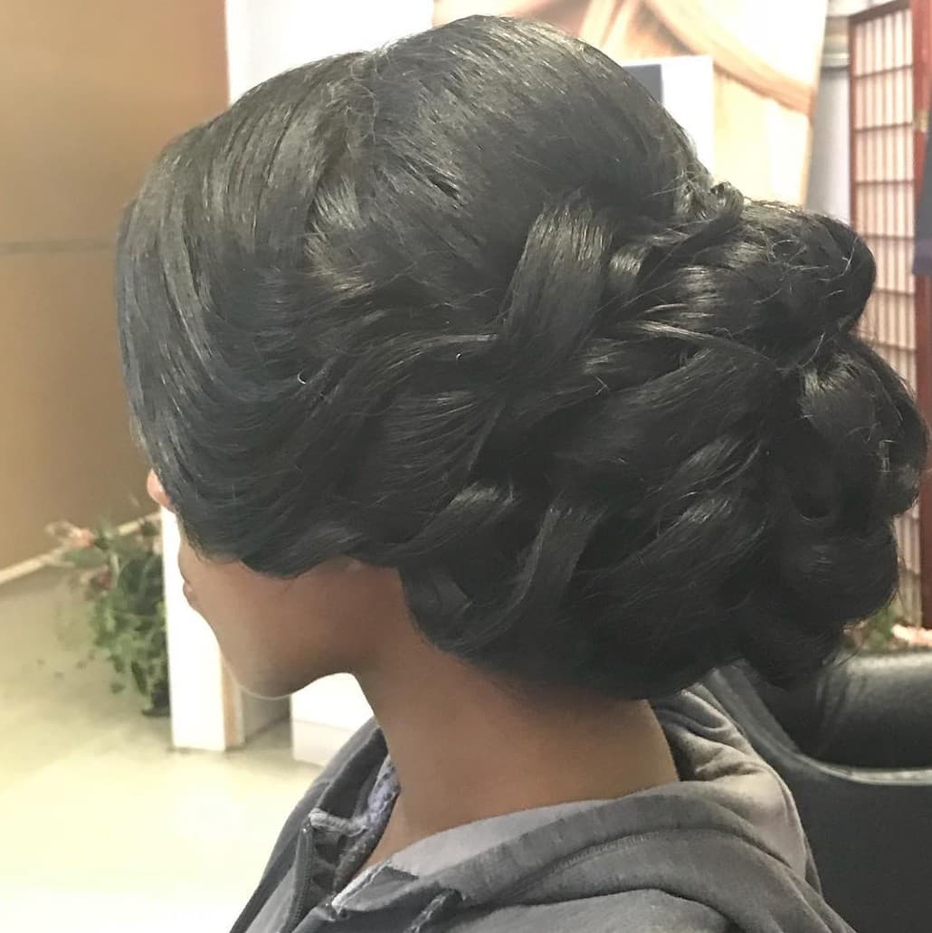 Intricate braided low bun updo styled by R&M Salon